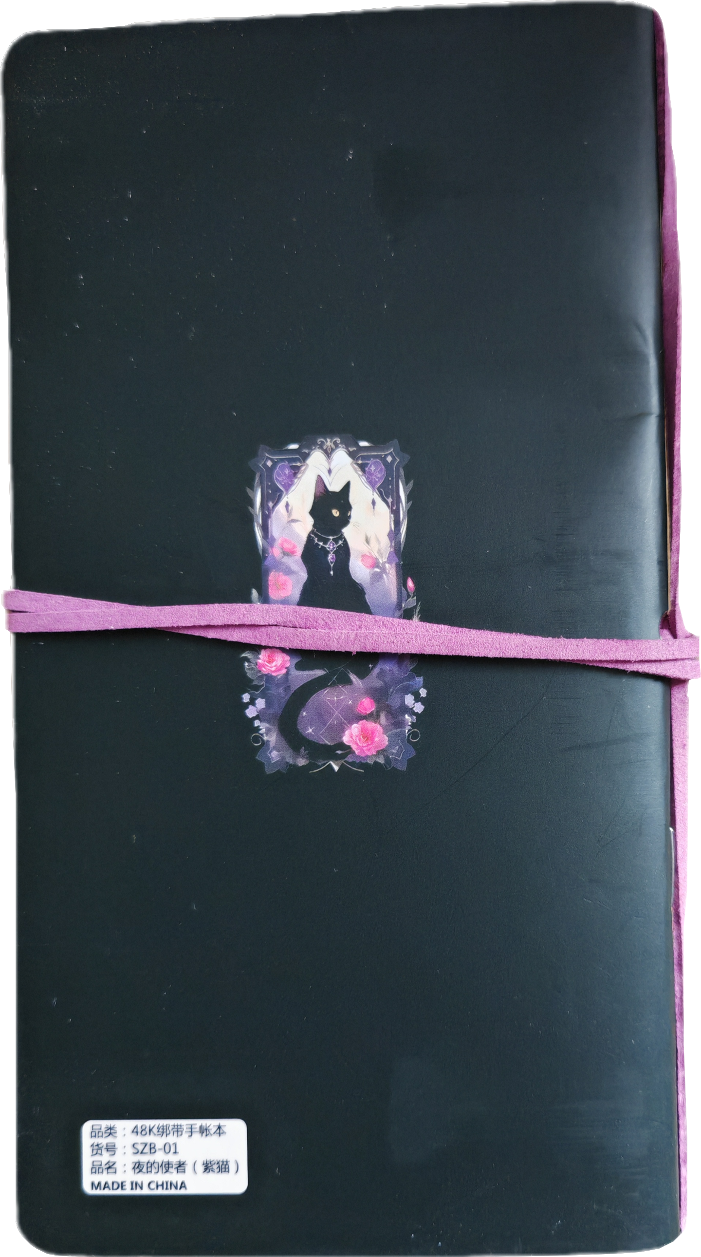 notitieboek met zwarte kat